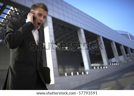 Young businessman calling on mobile phone, outdoor.