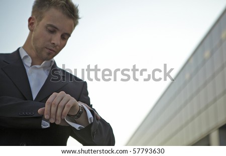 Checking the time. Worried young businessman