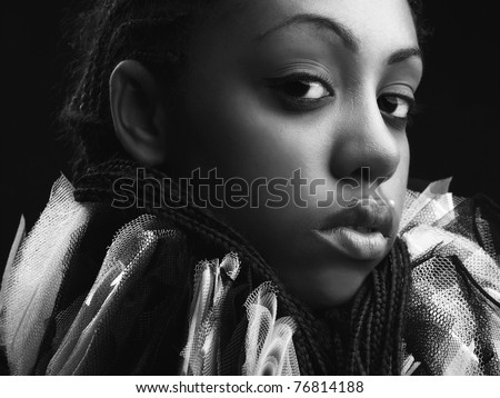 Attractive afro-american beauty in a black-white theatrical jabot. Close-up Portrait.