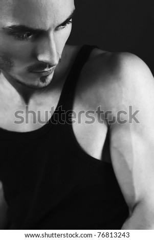 Muscular young fashion man with strong arms. Black-white.