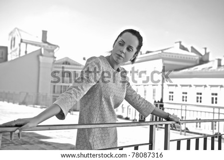Beautiful brunette woman walking on sunny day. Black-white outdoor series.