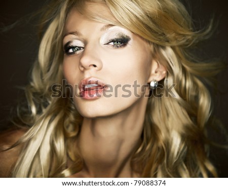 Amazing portrait of beautiful young blond woman. Close-up face studio photo.