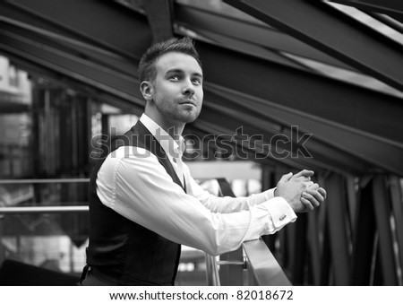 The young businessman in the workplace. Black-white photo.