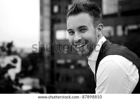 Black-white Portrait of an attractive young man outside.