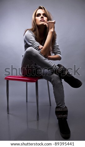 Gorgeous young woman sitting on a chair