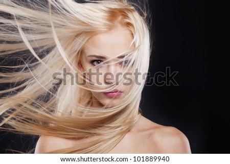 Fashion Portrait of beautiful blonde with the flying hair