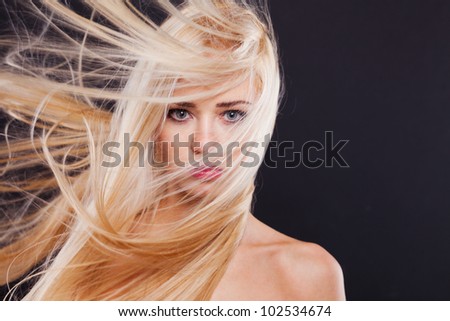 Fashion Portrait of beautiful blonde with the flying hair