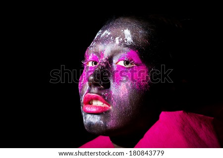 art photo of beautiful model with creative unusual black mask colorful makeup. black face