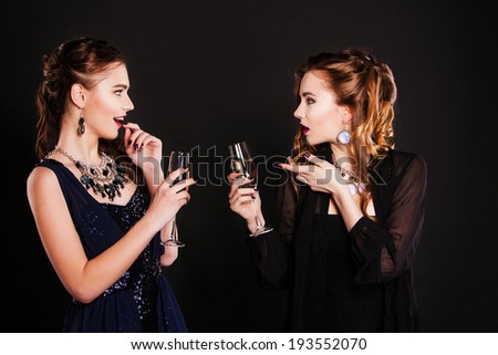 two Fashion woman with wine glasses of champagne