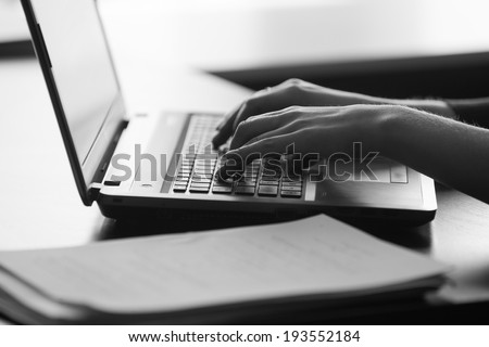 typing female hands on keyboard. black and white