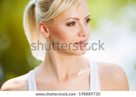 Close up portrait of a smiling healthy blonde woman. Sporty woman outdoor