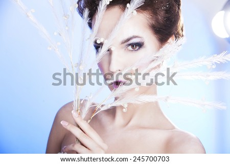 Beauty woman over winter background. Snow queen. Make-up