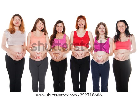 Group of pregnant happy women touching their bellies.