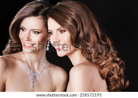 beautiful happy woman model with perfect makeup and curly hair wearing luxury jewelry