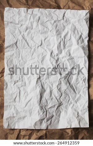 White crumpled paper on wrinkled beige paper for texture or background
