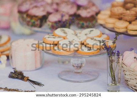 Dessert table for a wedding party. Wedding cookies decorated with lavanda flowers