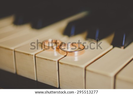 Wedding golden rings on vintage piano. Wedding accessories