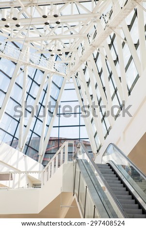Elevator in the modern futuristic interior with concrete arches on background