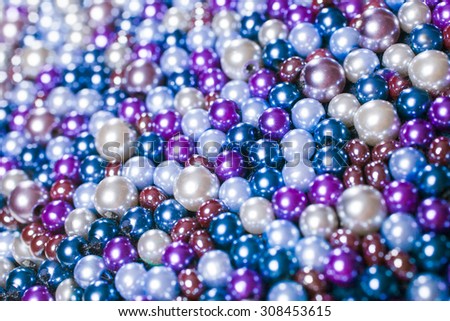 Pile purple balls of bead suitable for background and texture. Close up of colorful necklace pile