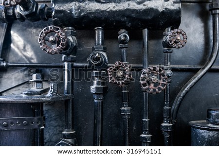 Steam punk black metal background. Background of engine room detail of a rare old steam locomotive