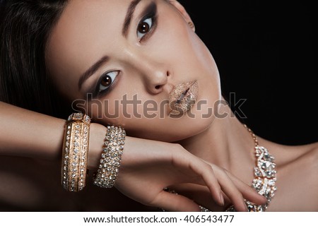 Beautiful young asian woman with elegant earrings and necklace