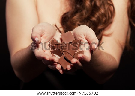A woman\'s hands holding on to a chocolate