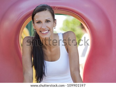 pretty brunette having fun in the playground in the park