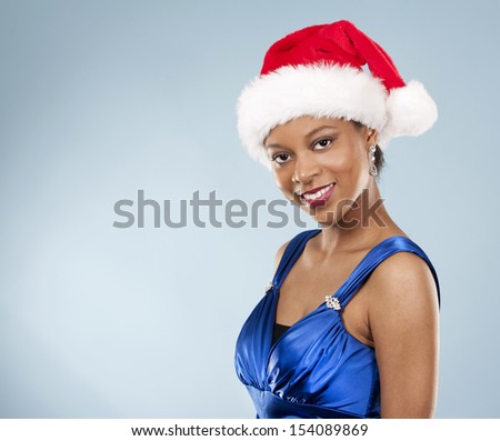 beautiful woman wearing blue evening dress and Christmas hat