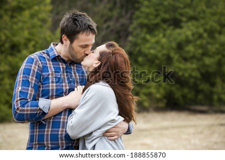 young couple wearing casual outfits in the park
