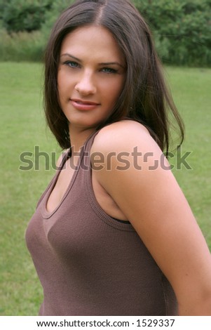 casual brunette with blue eyes in the green park