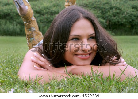 casual brunette with blue eyes in the green park