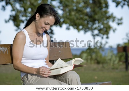 beautiful brunette sitting down reading book