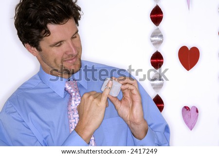 attractive man wearing formal blue shirt and black pants during valentines day
