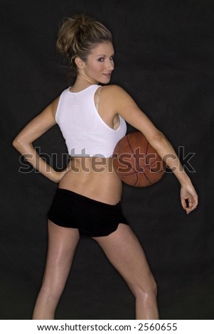 beautiful blond playing basketball wearing white shirt and black shorts