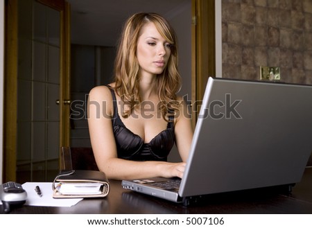 stunning woman working on laptop in her office