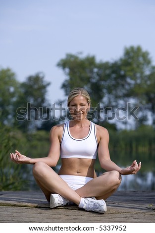 healthy fitness model doing yoga outdoors during summer