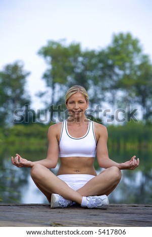 healthy fitness model doing yoga outdoors in the park