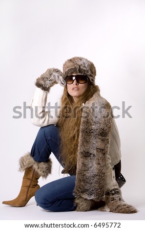 stunning woman wearing winter outfit with fur and glasses