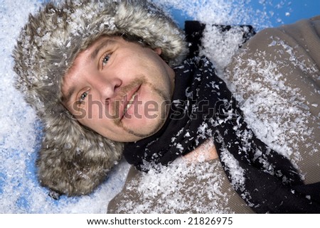 russian man wearing fur with snow on blue