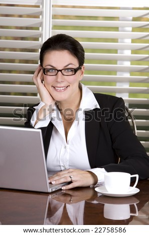 pretty business woman holding a cup of coffee