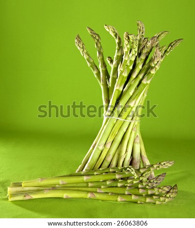 fresh green bunch of asparagus on green background