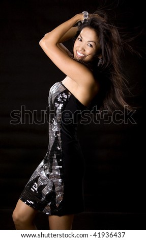 pretty brunette woman having fun on black background