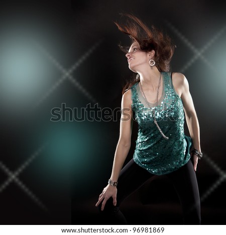 pretty brunette wearing green outfit on black background