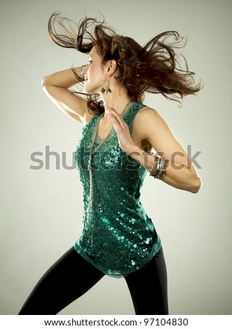 pretty brunette wearing green outfit on light background