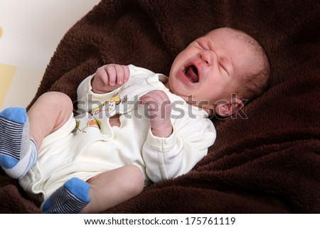 Little newborn baby boy one month old crying