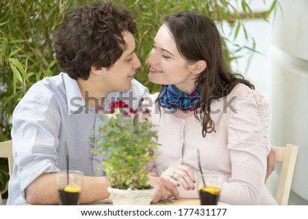 Love couple in shopping center drinking beverage after shopping