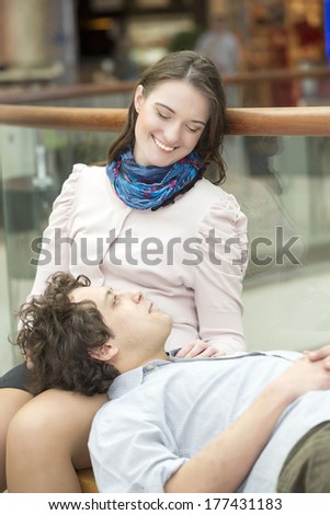 Love couple in shopping center resting after shopping