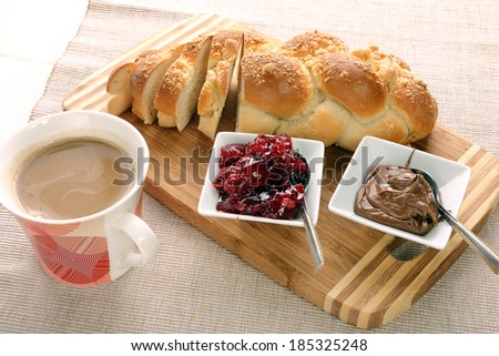 Sweet bread with cherry jam, and chocolate. Continental breakfast.