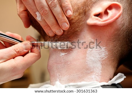 Barber shave and modeling beard at the hair salon