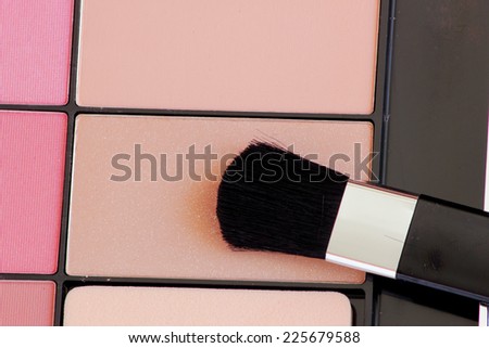 close up of a make up powder and brush